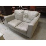 A pale green leather two seater settee