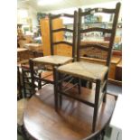 A pair of oak framed single chairs with seagrass seats