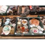 Three trays of ceramic ware to include cups, plates, tea pot, light shade etc.