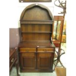 A modern oak Welsh dresser with a dome topped rack over two drawers and two cupboard doors