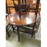 An early 20th century oak drop leaf table with barley twist legs