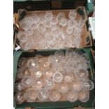 Two trays of cut glass drinking vessels