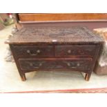 A 19th century carved pine low level chest of two short over one long drawer