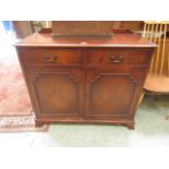 A reproduction sideboard having two drawers above cupboard doors