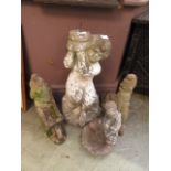 Four composite stone garden ornaments of gnomes, children,