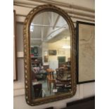 An ornate gilt framed arch topped mirror