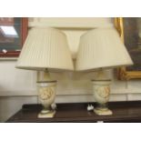 A pair of modern table lamps with classical urn design columns