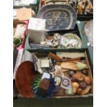 Two trays containing wooden fruit, blue and white meat plate, boomerang, ladies slippers,