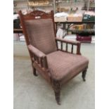 An Edwardian walnut framed open arm parlour chair