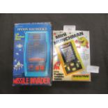 A small boxed Missile Invador with a boxed Mini Munchman