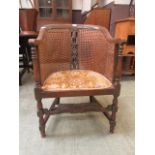 A caned upholstered oak frame tub chair