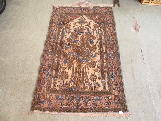 A hand woven Indian rectangular multi coloured rug depicting the tree of life