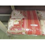 A red and cream quilted bed throw measuring 250cm by 265 cm