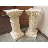 A pair of cream painted Corinthian column pedestals