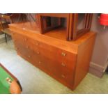 A teak sideboard having a bank of six drawers