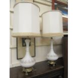 A pair of American white glass and parcel gilt table lamps