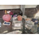 A selection of glass paper weights together with a Caithness perfume bottle