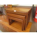 A nest of three mid-20th century teak occasional tables