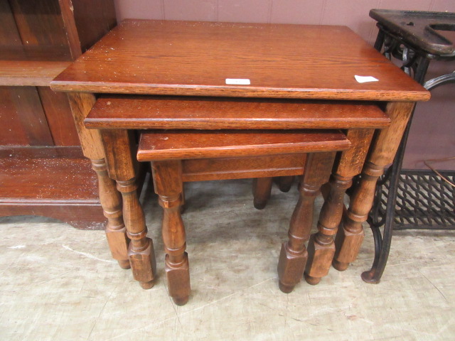 A nest of three reproduction oak and beech tables