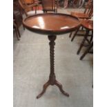 An oak pedestal wine table with barley twist support