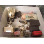 A box containing coinage, cuff links, paper notes, trophy etc.