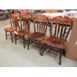 A set of four late 20th century rail back dining chairs