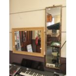 A modern pine effect wall mirror together with one other
