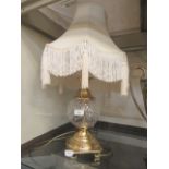 A gilt metal and glass table lamp with shade