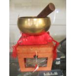 A boxed oriental brass singing bowl
