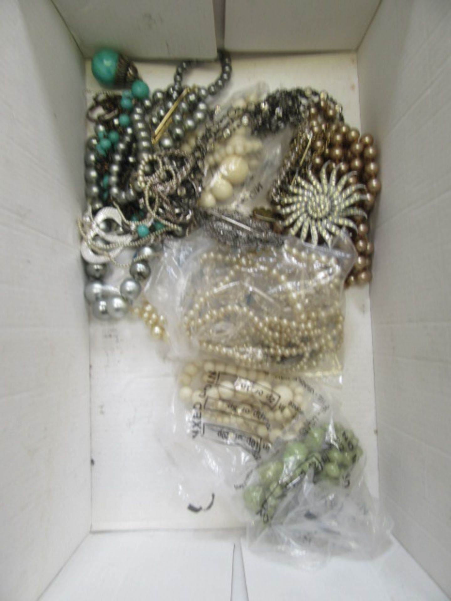A box of costume jewellery including beads