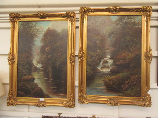 A pair of gilt framed oil on canvases of river scenes one signed W.