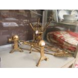 An assortment of brass items to include fireside companion set, fire dogs, trivet etc.