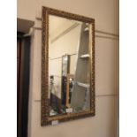 A rectangular ornate gilt framed bevel glass wall mirror