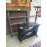 A set of green painted wall hanging shelves along with a black painted occasional table