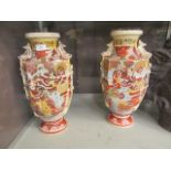 A pair of oriental vases decorated in a gilt and red decoration