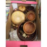 A tray of wooden treen items to include bowls, egg cups etc.