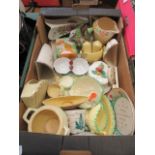 A tray of assorted mid-20th century ceramic ware to include pouring jugs, cheese dishes etc.