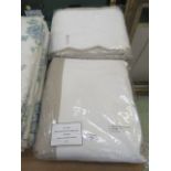 Two bagged white and beige duvet cover and pillow case sets