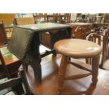 A carved oak drop leaf occasional table along with a turned three leg stool