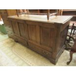 A 19th century oak cabinet having two cupboard doors above two drawers on bracket supports