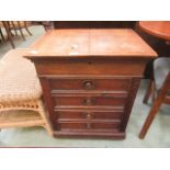 An early 20th century oak four drawer cabinet