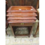 A nest of four eastern hardwood carved top brass inlaid occasional tables