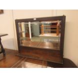 An early 20th century oak over mantle mirror with bevelled glass