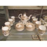 A Victorian part tea set with gold design comprising of tea pot, cups and saucers etc.