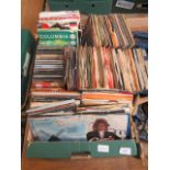 A tray of 45 rpm records and CDs by various artists