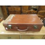 An early 20th century leather travelling suitcase