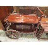 An eastern hardwood two tier tea trolley with brass inlay design