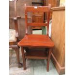 An early 20th century metamorphic library chair