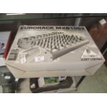 A boxed Behringer Eurorack MXB1002 mixing desk