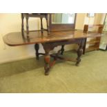 An early 20th century oak extending dining table,